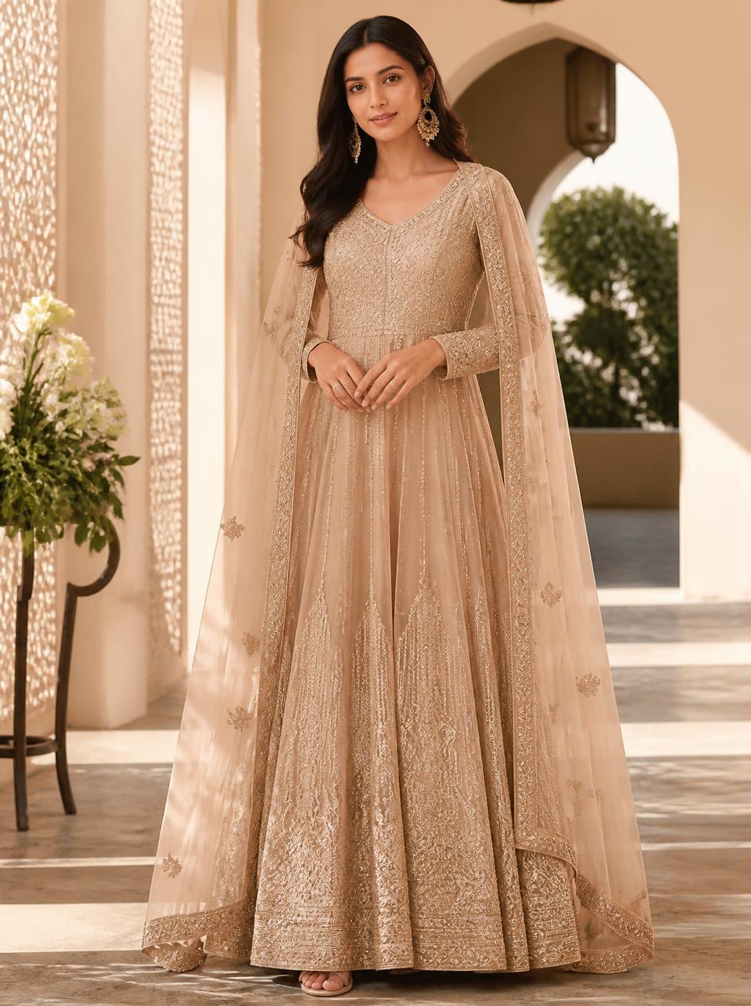 Woman in a champagne anarkali with a long embroidered dupatta